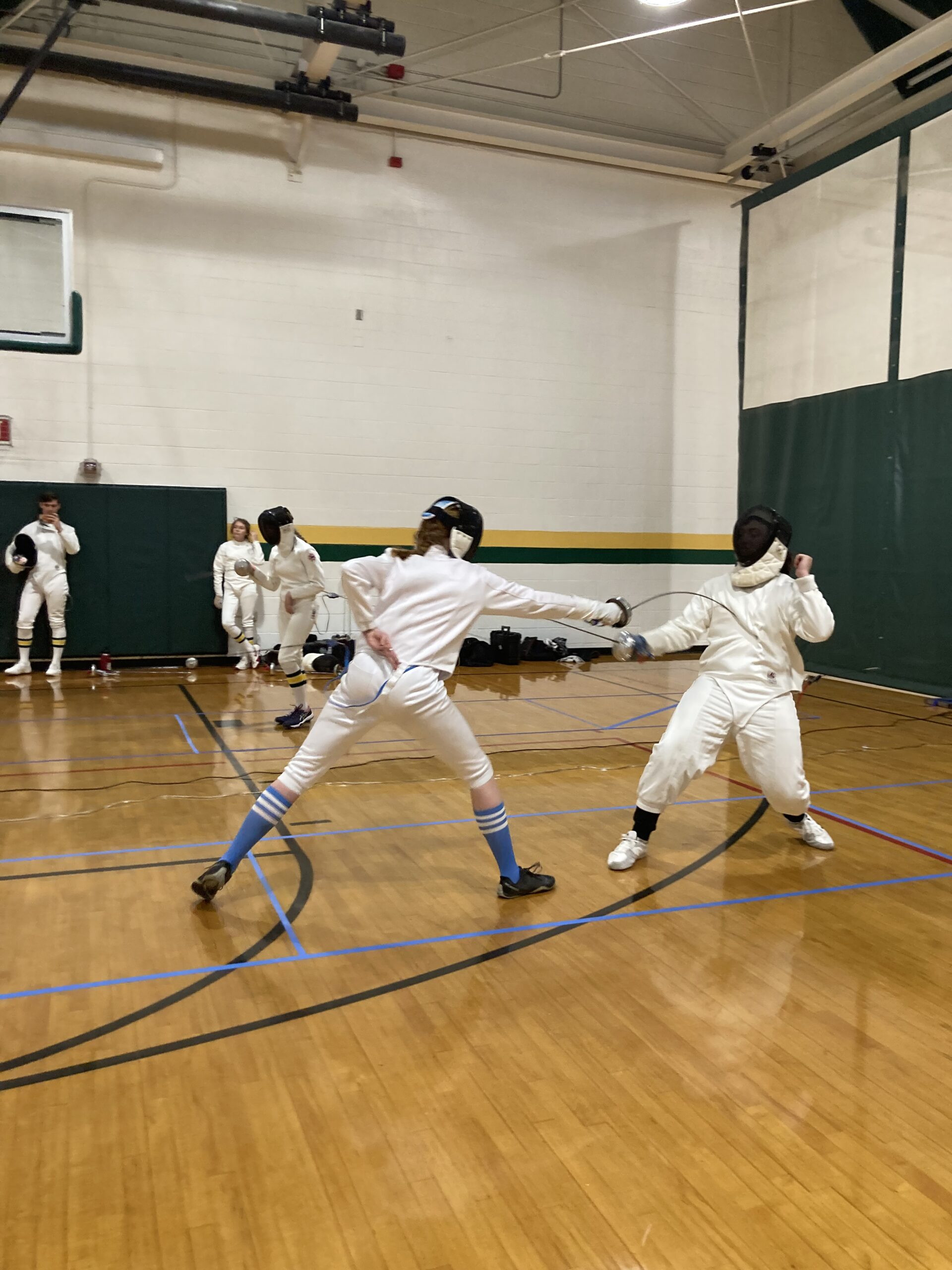 Two fencers fighting in a tournament at William and Mary. 